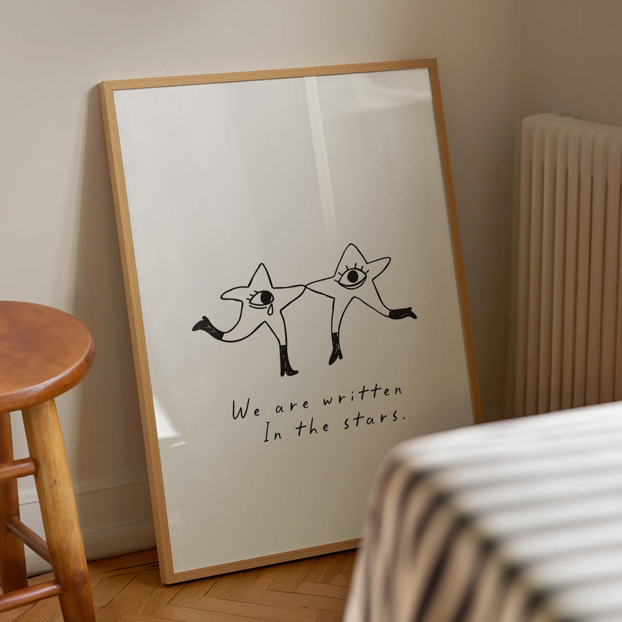 Illustrated celestial print with two dancing star characters and the phrase 