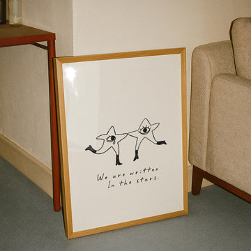 Illustrated celestial print with two dancing star characters and the phrase 