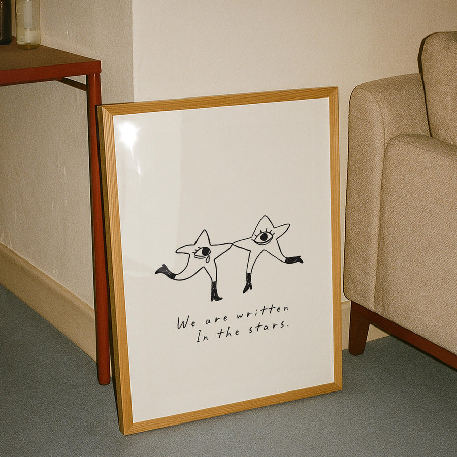 Illustrated celestial print with two dancing star characters and the phrase 