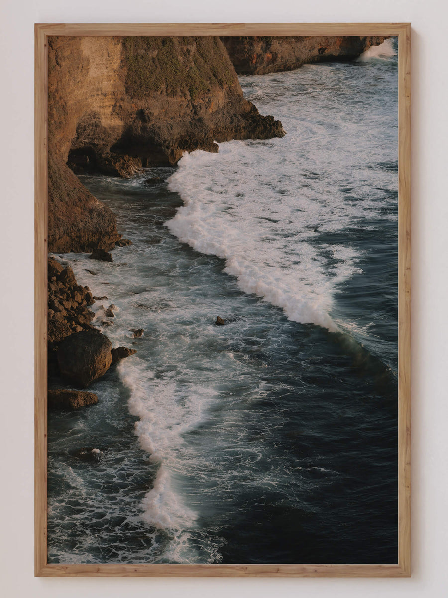Ocean Cliff Waves Print – Moody coastal wall art with ocean waves crashing into rocky cliffs at golden hour. Get 2PrintsFor$100 that comes with Free Shipping 🚚💫 in Australia.