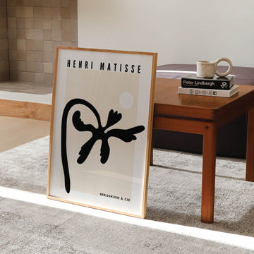 Matisse-inspired black palm abstract print featuring bold organic cut-out shapes against a neutral beige background. A modern and minimalist botanical wall art piece. Get 2PrintsFor$100 that comes with Free Shipping 🚚💫 in Australia.