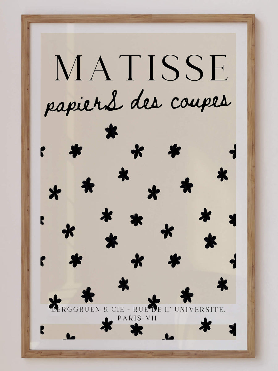 Matisse-inspired Stars Print featuring black floral cut-out shapes scattered on a neutral beige background. A minimalist and elegant botanical wall art piece. Get 2PrintsFor$100 that comes with Free Shipping 🚚💫 in Australia.