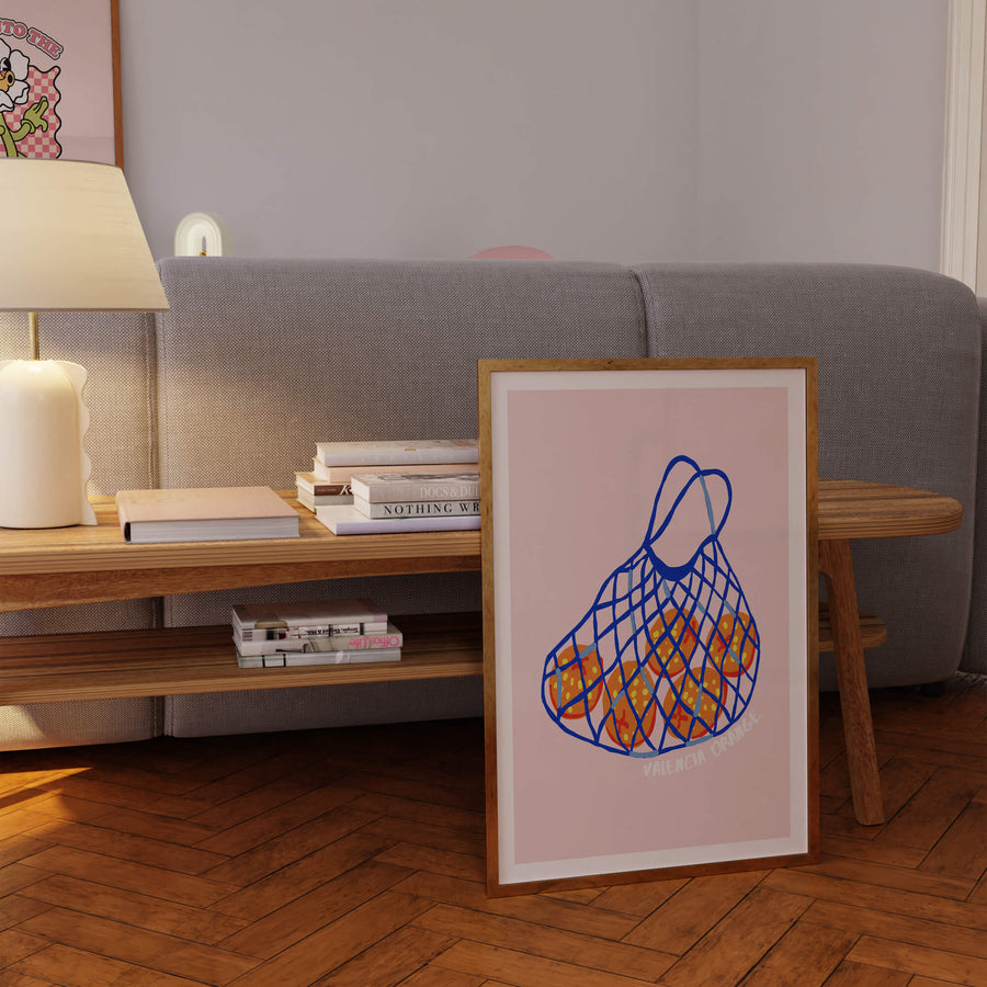 Illustrated Valencia oranges in a blue net bag on pink background – fruity retro kitchen wall art print. Get 2PrintsFor$100 + Free Shipping in Australia.